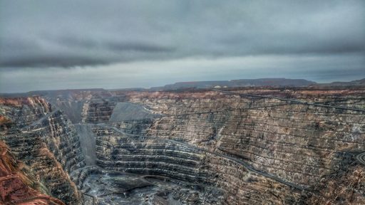 a view of a large open pit in the middle of nowhere