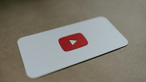 a red and white play button on a white card