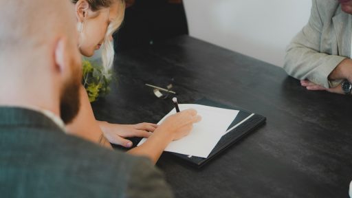 a man writing on a piece of paper