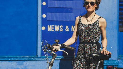 woman holding gray bicycle