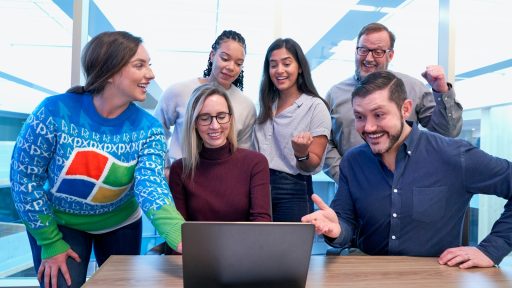 woman in maroon sweater using laptop